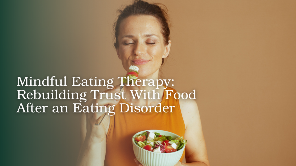 Woman practicing mindful eating while holding a bowl of salad and taking a bite