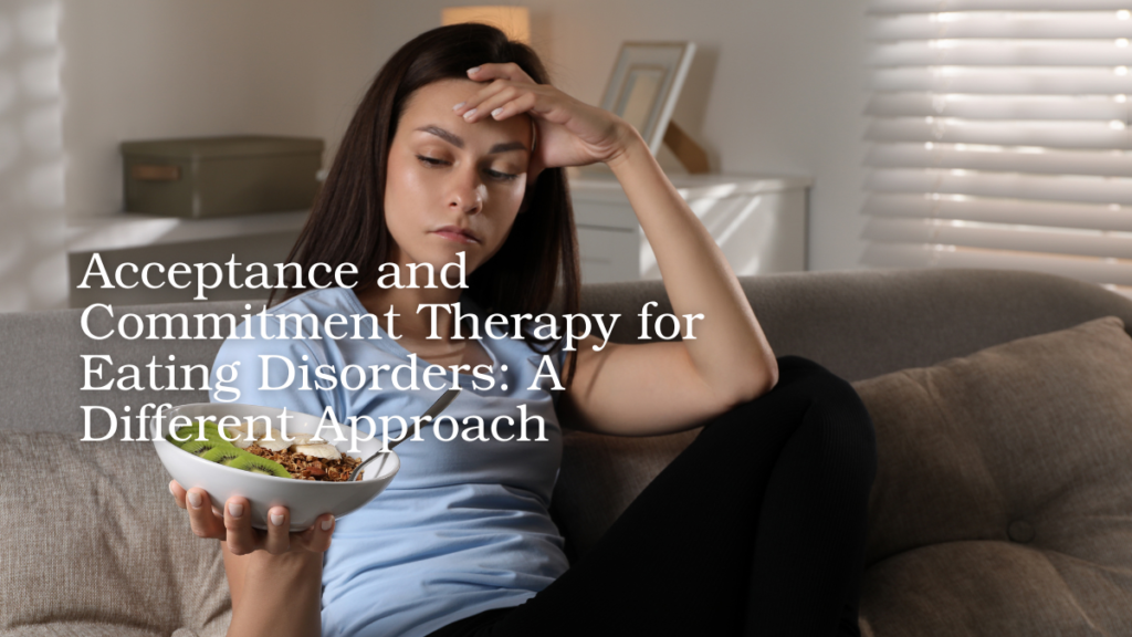 Woman sitting on a couch holding a bowl of food while appearing worried