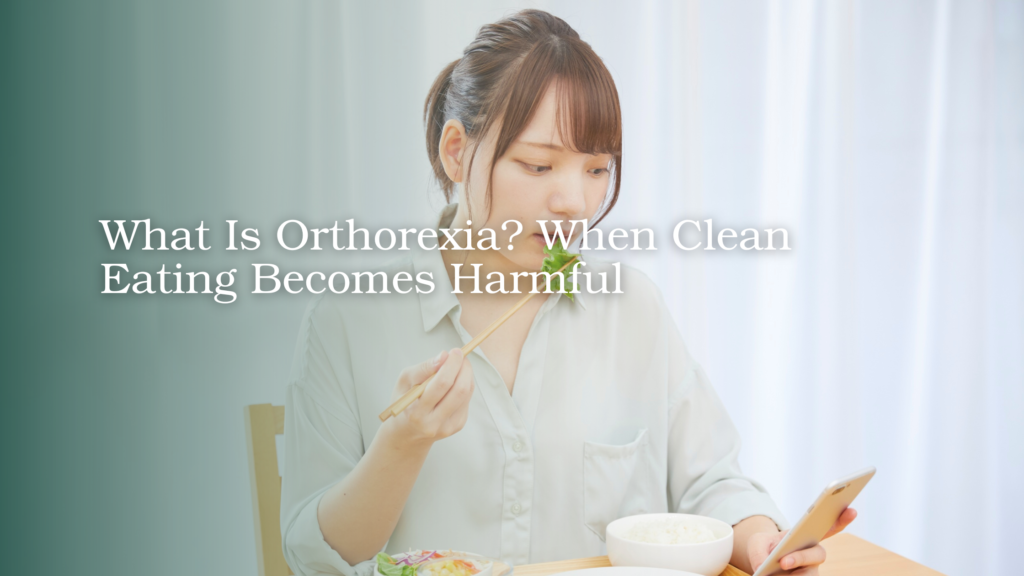 Young woman eating a healthy meal while holding a phone at the table