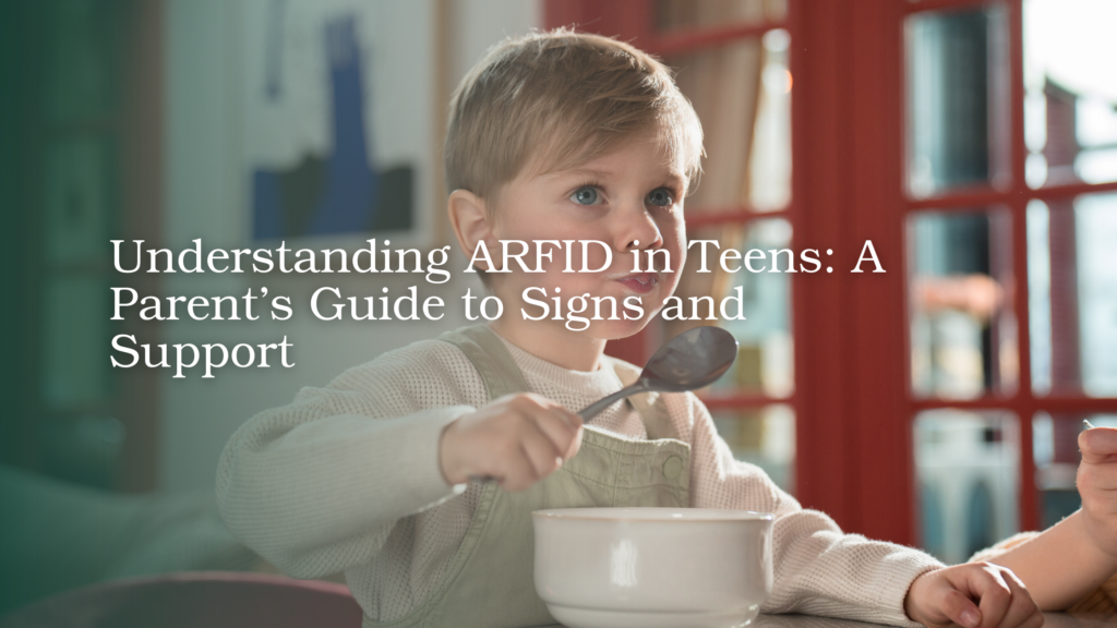 Young child eating a meal with support from a parent, illustrating ARFID and challenges around food